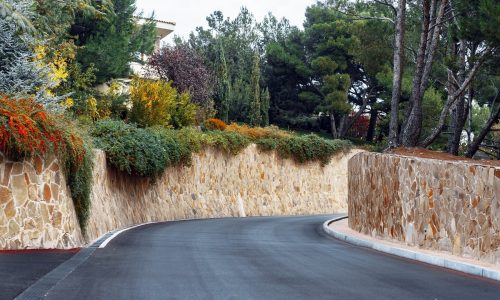 Picturesque concrete slope walkway with plants on the sides, background